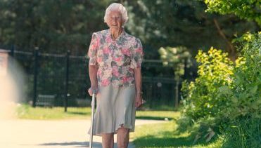 Active elderly lady walking in a park